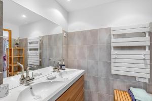 a bathroom with two sinks and a mirror at Chalet Ma Bonne Etoile in Les Prats +18 photos