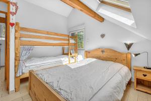 a bedroom with two bunk beds and a window at Chalet Ma Bonne Etoile in Les Prats