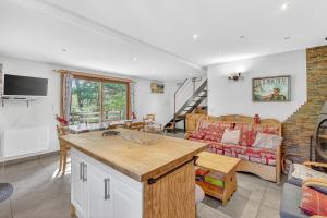 a kitchen and a living room with a couch at Chalet Ma Bonne Etoile in Les Prats