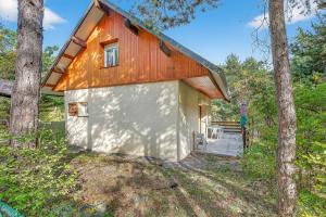 a small house with a red roof in the woods at Chalet Ma Bonne Etoile in Les Prats
