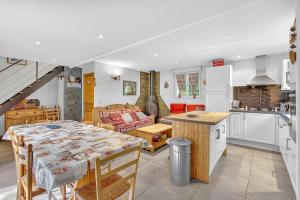a kitchen and a living room with a table in a kitchen at Chalet Ma Bonne Etoile in Les Prats