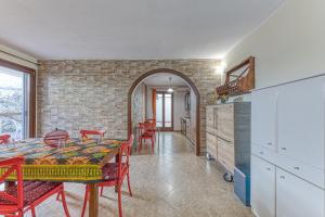 a kitchen and dining room with a table and chairs at Casa Castro Vista Grotta in Castro di Lecce +17 photos