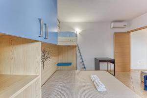 a kitchen with wooden cabinets and a blue shelf at Casa Castro Vista Grotta in Castro di Lecce
