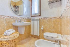 a bathroom with a sink and a toilet and a mirror at Casa Castro Vista Grotta in Castro di Lecce