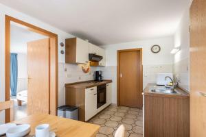 a small kitchen with a sink and a table at Fewo Nissen Dagebüll in Dagebüll
