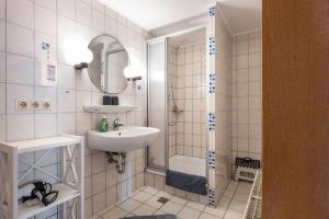 a white bathroom with a sink and a shower at Fewo Nissen Dagebüll in Dagebüll +32 photos