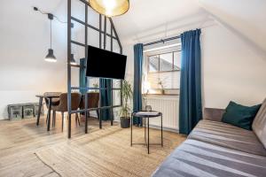 a living room with a couch and a table at Cosy Apartment In Soltau in Soltau