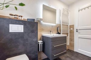 a bathroom with a sink and a mirror at Cosy Apartment In Soltau in Soltau +17 photos