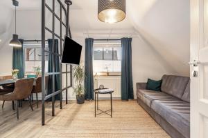 a living room with a couch and a table at Cosy Apartment In Soltau in Soltau