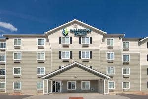 a large building with a sign on the top of it at WoodSpring Suites Killeen in Killeen