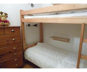 a bedroom with a bunk bed and a dresser at Chalet - Les 3 vallées in La Combe