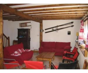 a living room with a red couch and chairs at Chalet - Les 3 vallées in La Combe
