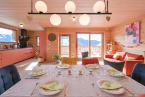 a dining room with a table with glasses on it at Appartement dans le Chalet l'Albert in Manigod +28 photos