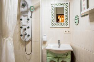 a bathroom with a sink and a shower with a mirror at La Plazuela I in Pereña +43 photos