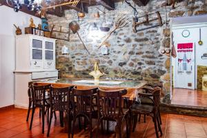 a kitchen with a large wooden table and chairs at La Plazuela I in Pereña