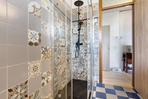 a bathroom with a shower and a tile wall at Casa Zoe in Arco +13 photos