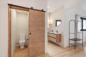 a bathroom with a toilet and a sink at Finca Los Tilos Moya in Moya +100 photos