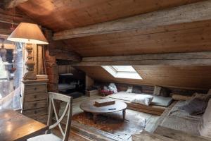 a room with a bed and a table in a cabin at Chalet authentique luxe piscine in Les Contamines-Montjoie