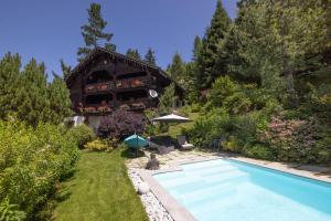 a house with a swimming pool in a yard at Chalet authentique luxe piscine in Les Contamines-Montjoie