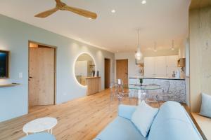 a living room and kitchen with a couch and a table at Valentinerhof Apt Air in San Michele