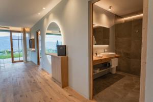 a bathroom with a sink and a mirror at Valentinerhof Apt Air in San Michele +34 photos