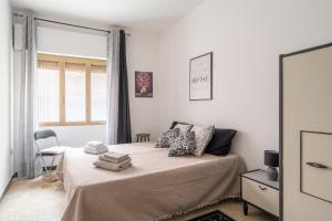 a white bedroom with a bed with a window at Jerzu Centro in Jerzu