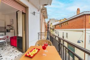 a table with a glass of wine on a balcony at Jerzu Centro in Jerzu
