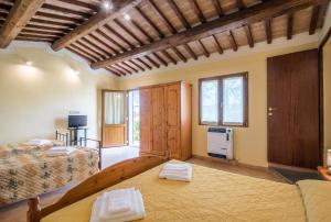 a bedroom with a bed and a couch in a room at Faetino - Pavone in Colle di Val d'Elsa +14 photos