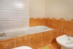 a bathroom with a tub and a toilet and a sink at A O - La Source in Peniche +14 photos