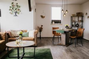 a living room with a couch and a table at Ferienwohnung Emma in Güntersberge