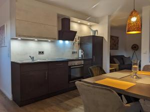 a kitchen and dining room with a table and a dining room at Ferienwohnung Auszeit in Niebüll