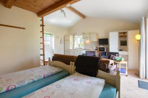 a bedroom with a bed and a living room at Apartment Eulenhof 2 in Bordelum