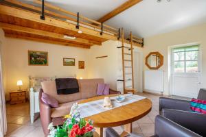a living room with a couch and a table at Apartment Eulenhof 2 in Bordelum