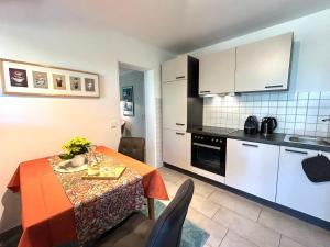 a kitchen and dining room with a table and chairs at Stella Lilia in Radolfzell am Bodensee