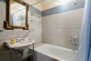 a bathroom with a sink and a bath tub and a mirror at Dimora Cariddi Otranto in Otranto +17 photos