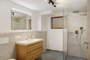 a bathroom with a sink and a shower at Beim Schweizer in Garmisch-Partenkirchen +44 photos
