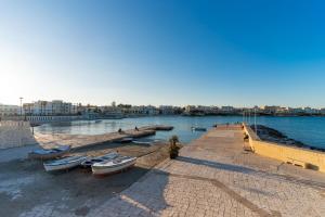 a group of boats on the shore of a body of water at Dimora Cariddi Otranto in Otranto