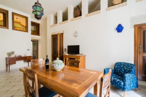 a dining room with a wooden table and chairs at Dimora Cariddi Otranto in Otranto
