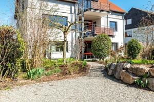 a house with a garden and a walkway at Stella Lilia in Radolfzell am Bodensee