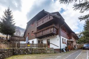 a house with wooden balconies on the side of it at Haus Maria in Todtnau