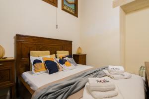 a bedroom with two beds with towels on them at Dimora Cariddi Otranto in Otranto