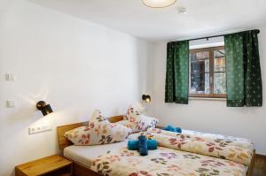 a bedroom with a bed with a teddy bear on it at Beim Schweizer in Garmisch-Partenkirchen