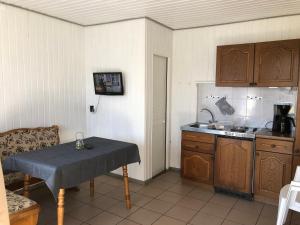 a small kitchen with a table and a sink at Bunte Ferienhaussiedlung in Rheinsberg