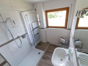 a bathroom with a shower and a toilet and a sink at Ferienhof Biegger in Tettnang