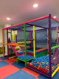 an indoor play room with a play structure with balls and slides at Chalet Del Sol in Puerto Lumbreras