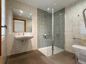 a bathroom with a sink and a glass shower at Villa Mila in Tera +21 photos