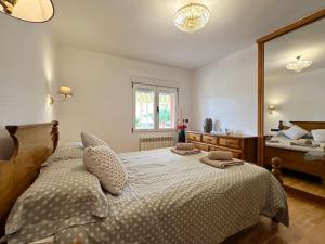 a bedroom with a bed and a large mirror at Villa Mila in Tera
