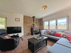 a living room with a couch and a tv at Villa Mila in Tera
