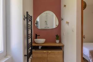 a bathroom with a sink and a mirror at Charmant Cottage - Saint-Junien in Saint-Junien +20 photos