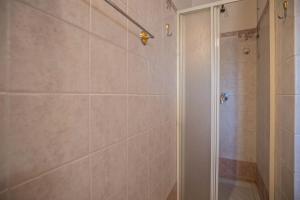 a shower with a glass door in a bathroom at Apt Gardasee Lazise Colá in Colà di Lazise +22 photos